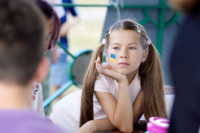 A young girl with the flag of Ukraine painted on her cheek at Farnham’s Ukraine Independence Day celebration