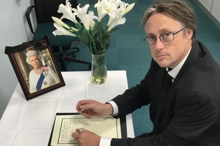 Cllr Richard Millard, East Hampshire District Council leader, signs the book of condolence held at Penns Place, Petersfield