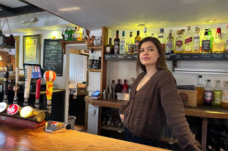 Maryna Haievska as a bar assistant at the Queens Head pub in Sheet