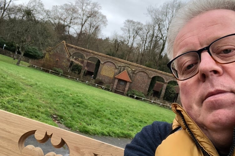 Andy Wyatt on the Batman bench he has had put in in Godalming to continue the legacy of his husband Daron Wyatt