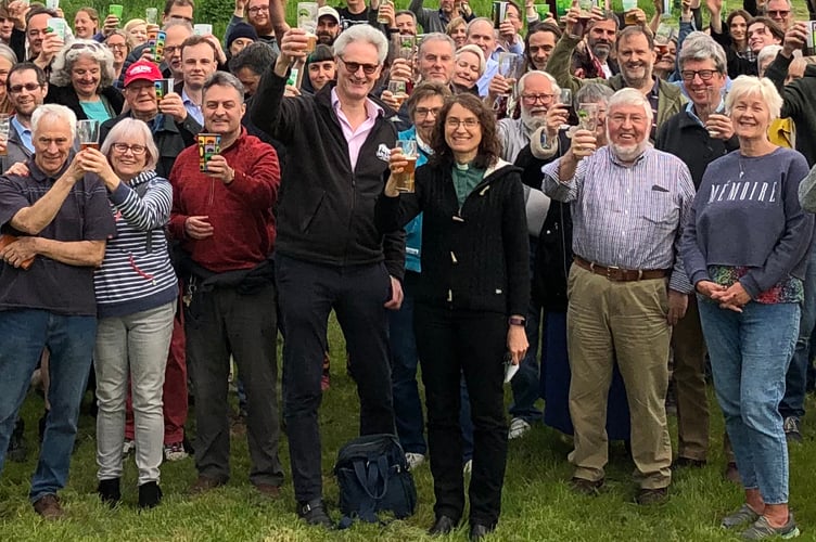 Guests raise a glass at the Hogs Back Brewery Hop Blessing, with managing director Rupert Thompson and Rev. Claire Holt (centre)