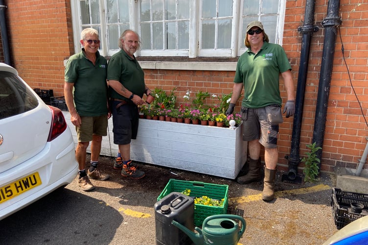 Farnham Town Council grounds staff plant the flower beds at the front of the Herald office in Union Road in the build-up to In Bloom judging day