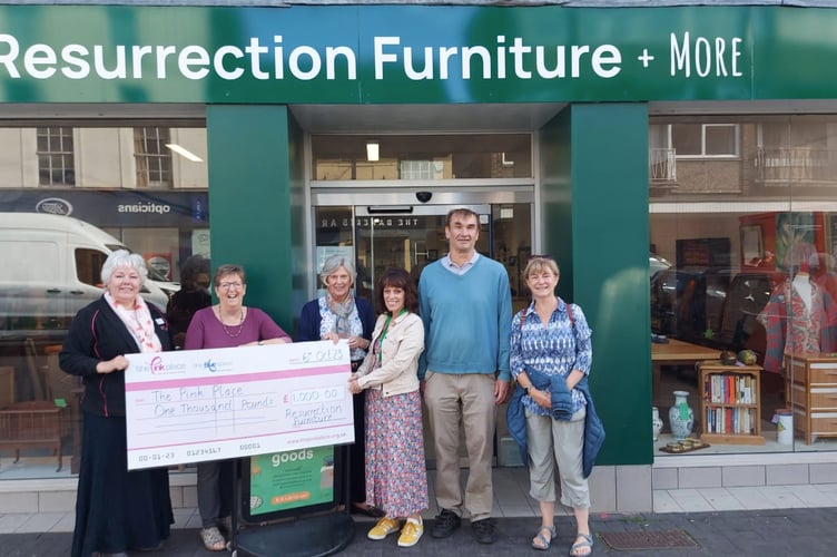 Resurrection Furniture, Alton High Street, hands over a £1,000 cheque to the Pink Place Alton, October 2023.