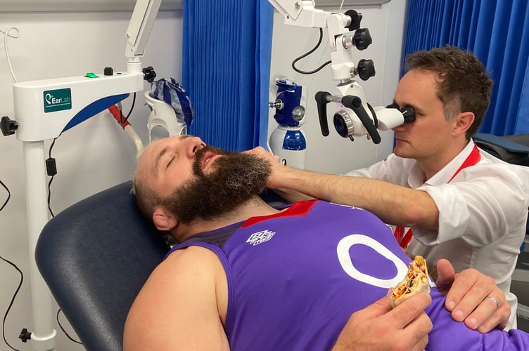 England and Harlequins rugby player Joe Marler gets treated by Earlab's David Walker