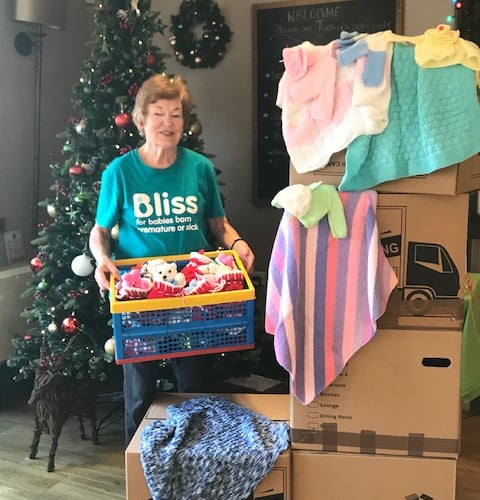 Dianne with just five of the 38 boxes full of knitted goodies, plus one of the 28 crates of stockings and teddies