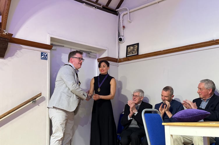 Anabel, the owner of Haslemere’s Green and Blue Studios, receives her  medal